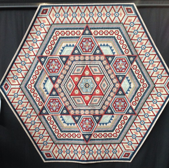 An amazingly tiny hexagon quilt didn't get the maker's name sorry